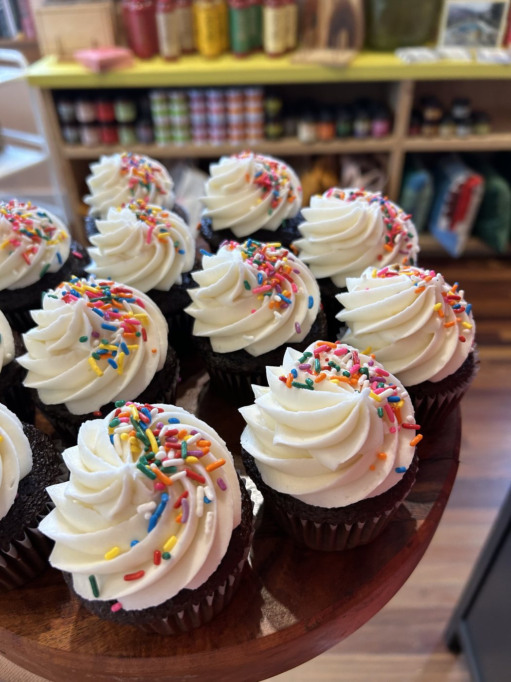 Chocolate cupcakes with vanilla buttercream swirls and rainbow sprinkles