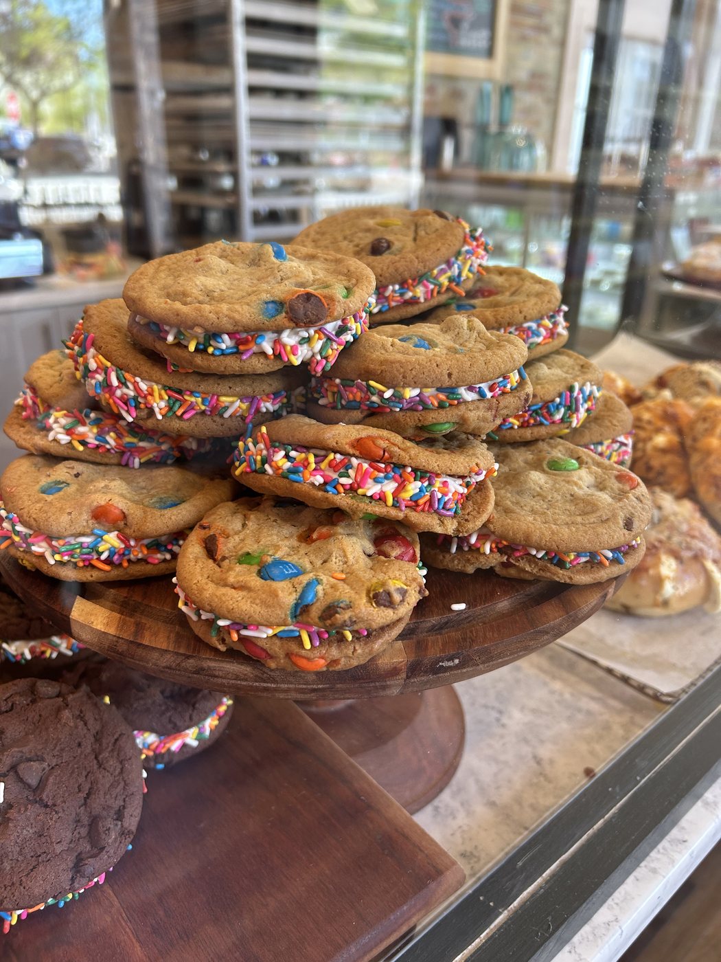 M&M cookie sandwiches with sprinkle-rimmed buttercream