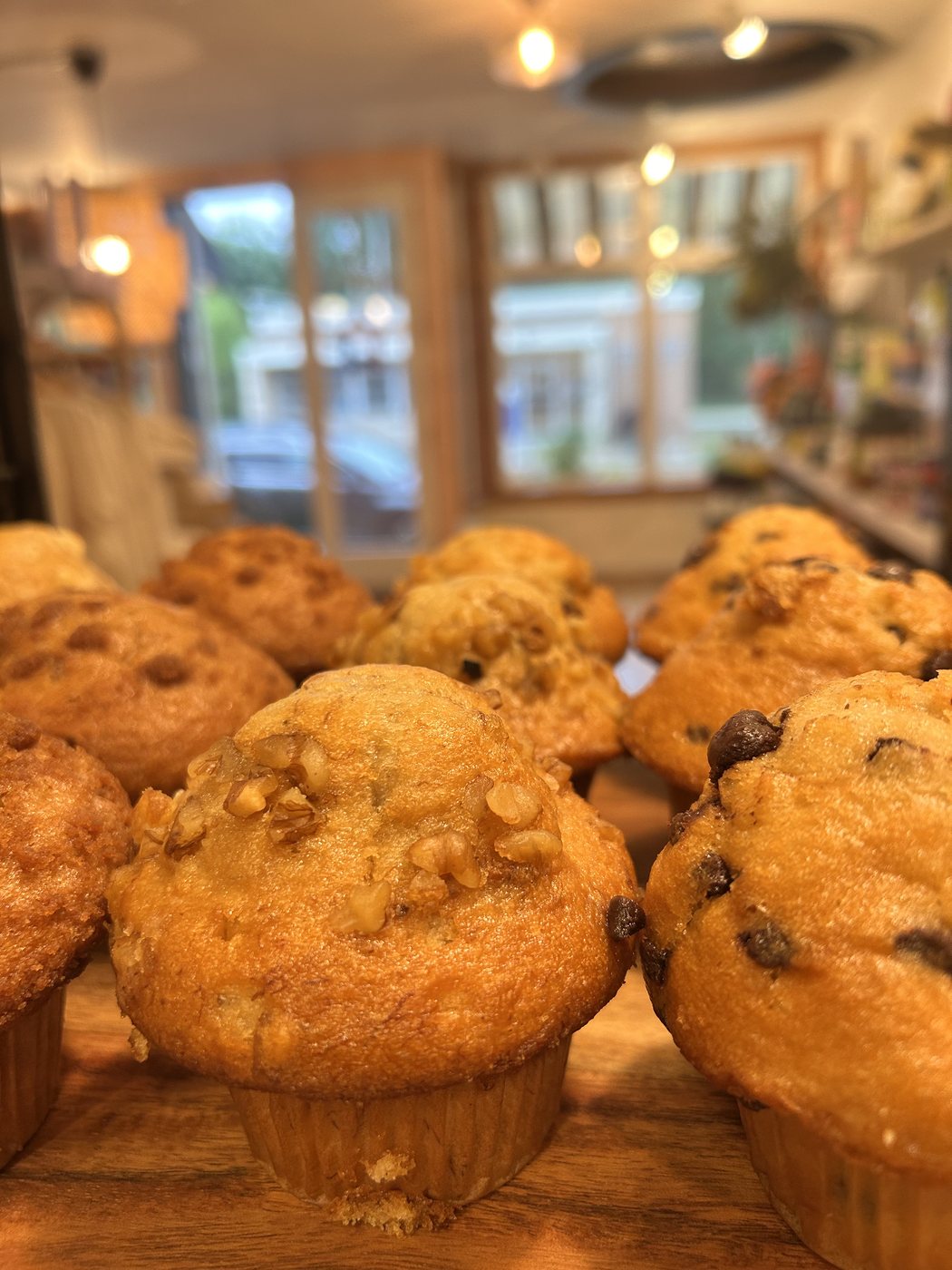 Fresh-baked muffins on a wooden board