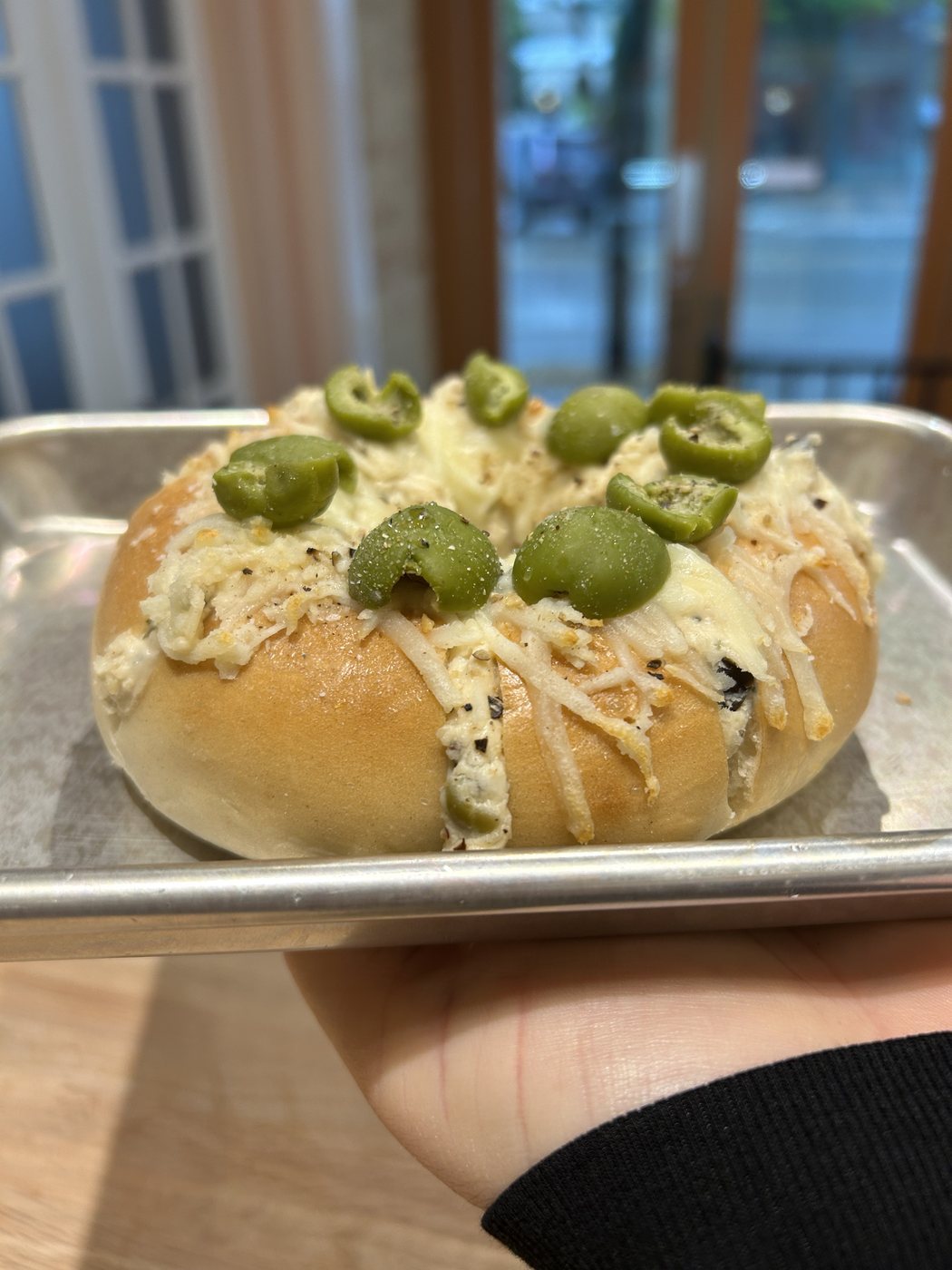 Stuffed bagel with herbed cream cheese and green olives