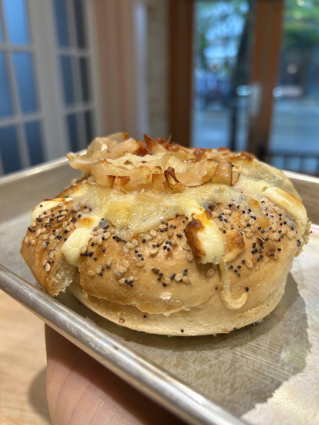 Turkey and cheese stuffed everything bagel with caramelized onion