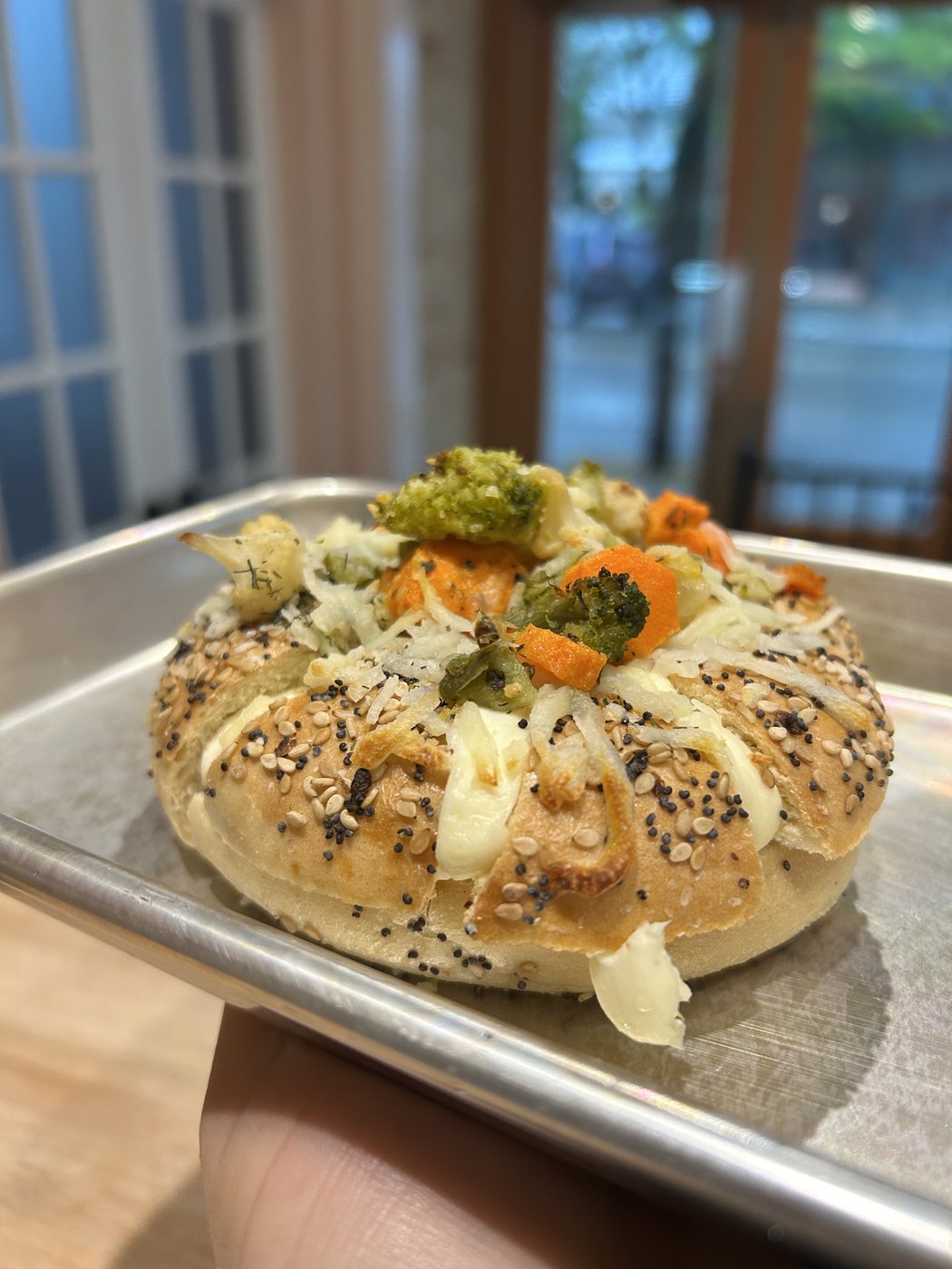 Roasted vegetable stuffed bagel with broccoli, carrots and cauliflower